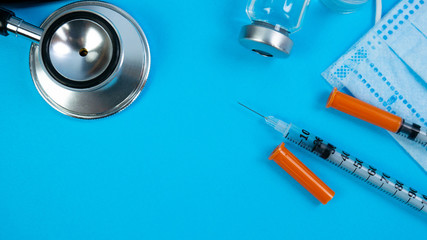 Insulin vial and syringe on blue background. Health care, doctor, clinic or hospital, medical...