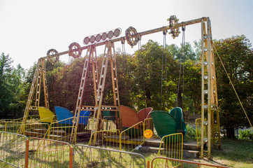 Old abandoned colorful attractions in the park in day under sunshine