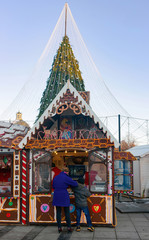 Christmas candy house and visitors on Vilnius Cathedral square Advent
