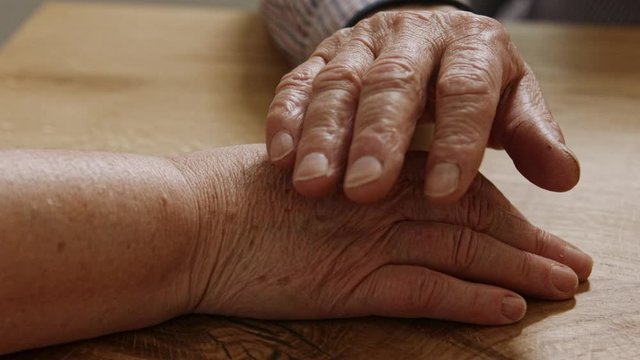 Senior man separating different medications. close up shot on the wrinkled elderly hands