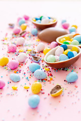 Fototapeta na wymiar Chocolate Easter eggs with multi-colored candy decorations. Copy space 