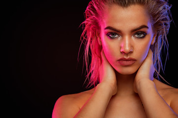 Naklejka premium Young blonde woman posing on light background