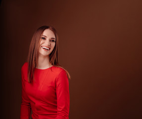 girl with long hair in red. dark copy space.