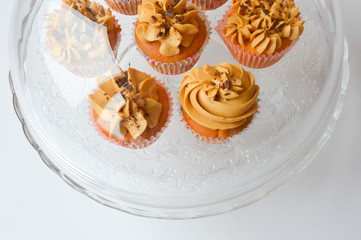 the bun with cream. delicious cupcake. delicious cake with air cream and nuts on a white background. home-made pastry.