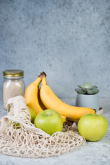 Eco-friendly shopping bag, zero waste concept, shopping bag with fruit, bananas, apples and a glass jar with cereals