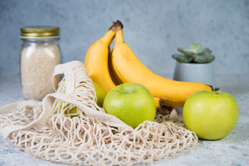 Eco-friendly shopping bag, zero waste concept, shopping bag with fruit, bananas, apples and a glass jar with cereals, trends