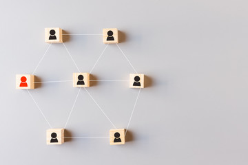 Top view of Wooden block with people icon on gray background. Leadership with idea and innovation, business teamwork, connection, team building concept.