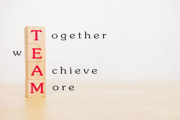 Motivation and Teamwork concept. Wooden block stack up and word TEAM on wooden table. With copy space for your text.
