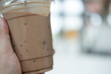 Iced mocha coffee in man hand