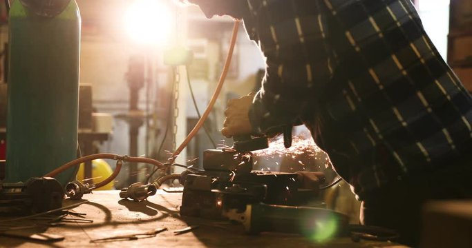 Bladesmith working with angle grinder