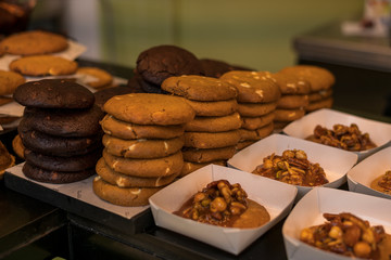 Appetizing desserts, pastries, delicious cookies are laid out in the cafeteria or bakery on the bar counter. Healthy gluten-free pastries. Horizontal view.