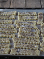 Shortbread on a black baking sheet from the kitchen oven.