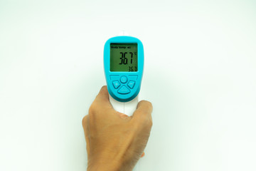 Hand holding non-contact infrared thermometer isolated on white background to measure a body temperature.