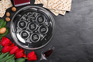 Flat lay composition with Passover Seder plate (keara) on black table, space for text. Pesah...