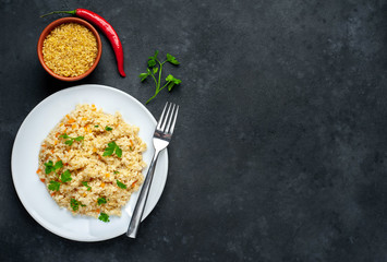  Bulgur with vegetables on a stone background with copy space for your  text. Healthy eating
