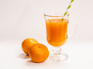 Fresh tropical fruits and a glass of juice on white background.