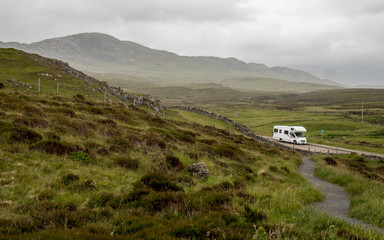 Motorhome touring in the Scottish Highlands. A view over the Highlands of Scotland with an RV parked up in a layby along the North Coast 500 route. - 331242419