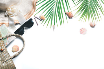 Traveler accessories, tropical palm leaf branches and big hat isolated
