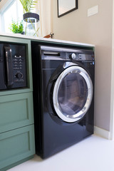 modern and new washing machine  in the kitchen counter.