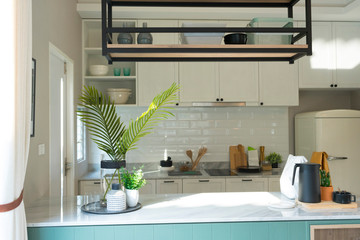 Modern kitchen island and counter with built in cabinets in cozy home.