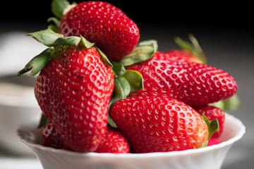 Delicious seasonal red strawberries, in preparation to be made and tasted. Very rich and healthy food