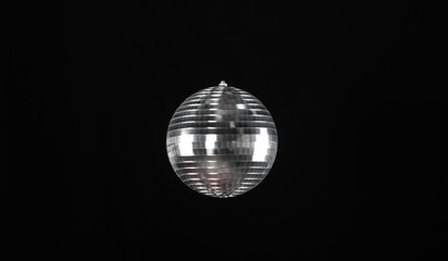 glowing mirror entertainment disco ball isolated on black background
