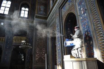 A member of Istanbul's Municipality disinfects the mosque in Istanbul to prevent the spread of the...