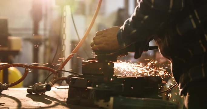 Bladesmith working with angle grinder