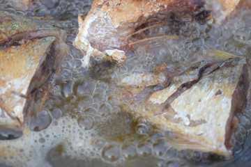 Tuna frying with oil to boil in a pan
