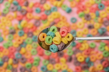 Fototapeta na wymiar selective focus of bright colorful breakfast cereal in spoon
