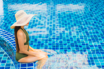 Portrait beautiful young asian woman relax around swimming pool in hotel resort