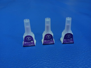 Photo Insulin Pen needles at blue imitation leather bed