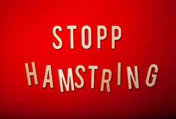 stopp hamstring norwegian word text wooden letter on red background coronavirus covid-19