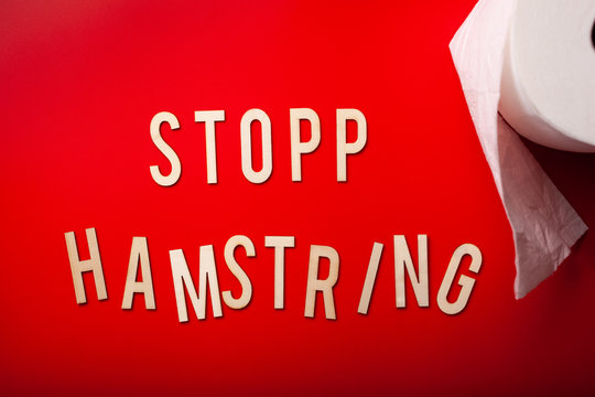 stopp hamstring norwegian word toilet paper text wooden letter on red background coronavirus covid-19