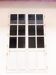 Obraz na płótnie Canvas The high door has six glass vaults on a white wall.