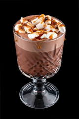 Cocoa with marshmallows and caramel. On dark background