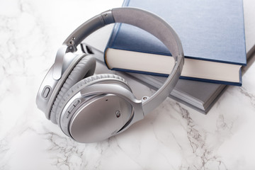 audiobook concept modern wireless headphones and book