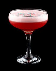 Exquisite original cocktail, decorated with colorful grains. On dark background