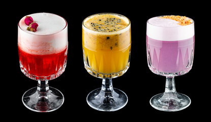 Exquisite original cocktails on a black background. Passion fruit, rose, plum.
