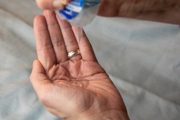Close-up of squeezing out hand sanitiser