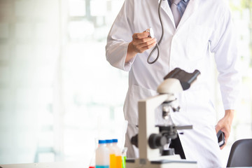 The doctor is testing a sample of biological tubes contaminated by Corona-virus Covid 19 and searching for a vaccine or Syrup against the virus. In the laboratory and film samples of infected lung