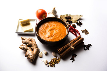 North Indian basic Curry for paneer butter masala or chicken makhanwala recipe shown with ingredients, served in a bowl. selective focus