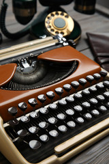 Vintage typewriter on grey wooden table, closeup. Detective's workplace