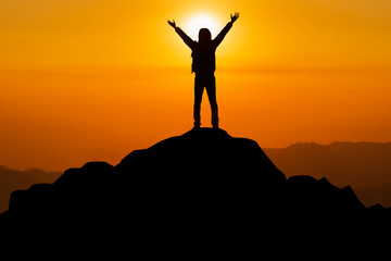 The silhouette of the man who successfully climbed the top of the mountain