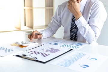 Business men analyze financial graphs and find break-even points for investments in order to reduce costs and reduce corporate taxes, Analysis of financial accounting concept.