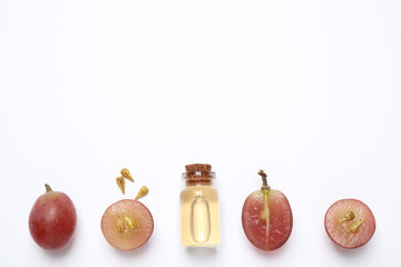 Composition with natural grape seed oil on white background, top view. Organic cosmetic