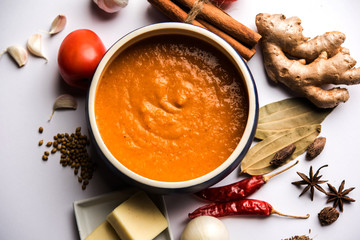 North Indian basic Curry for paneer butter masala or chicken makhanwala recipe shown with ingredients, served in a bowl. selective focus