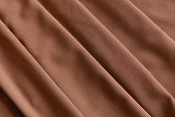 Fototapeta premium Soft light brown folded fabric for background.