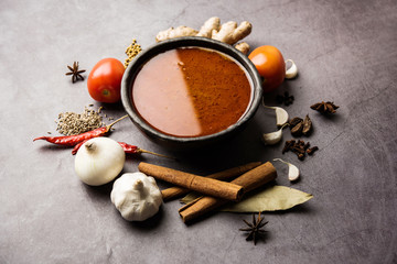 North Indian basic spicy Curry or masala for vegetables or chicken or mutton recipe shown with ingredients, served in a bowl. selective focus	homemade, restaurant, hot, oil, dark, red, indian, india, 