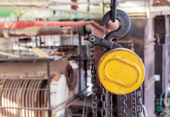 Hook on a beam crane for lifting and moving cargo in production rooms.